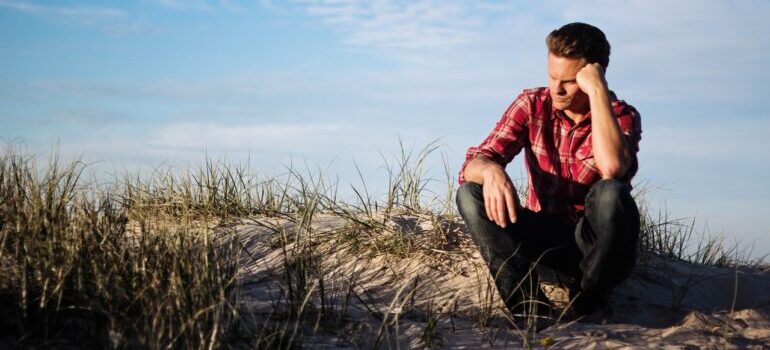 A man sittin in nature and pondering meaning of life and USDOT numbers.