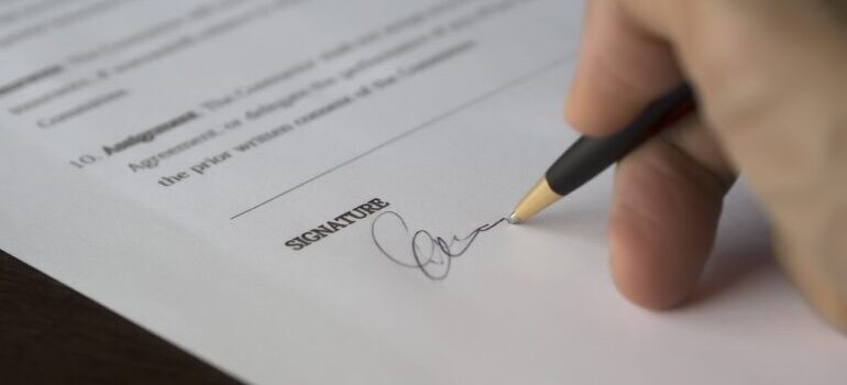 A person signing a contract.