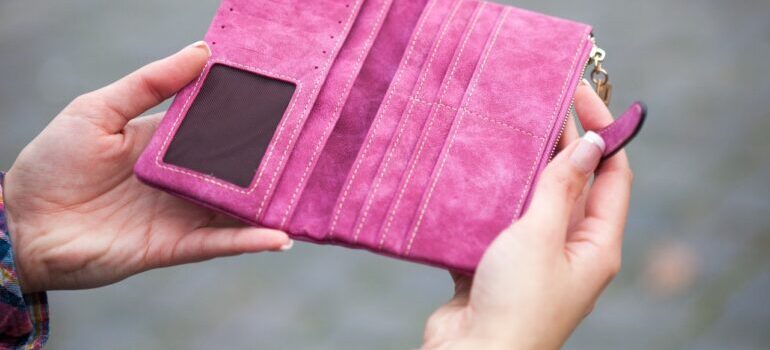 A person holding an empty wallet.