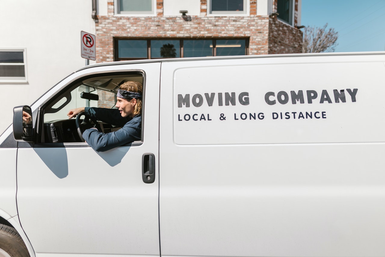 A mover smiling in a moving van.