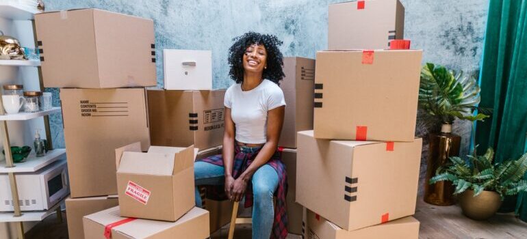 A woman surrounded by moving boxes