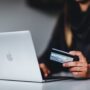 woman holding a credit card and thinking about Unexpected moving problems