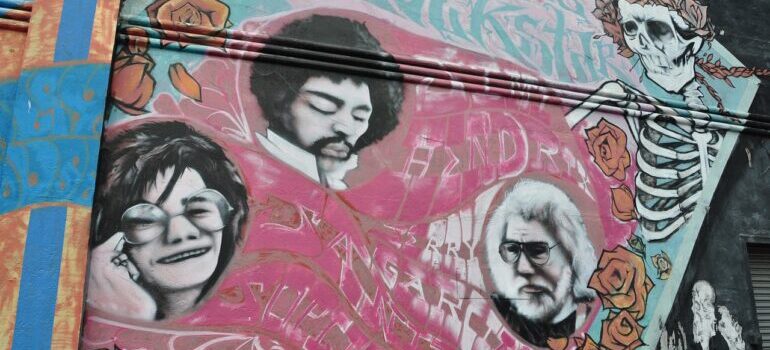 A mural of Jimmy Hendrix, Jerry Garcia, and Janis Joplin.