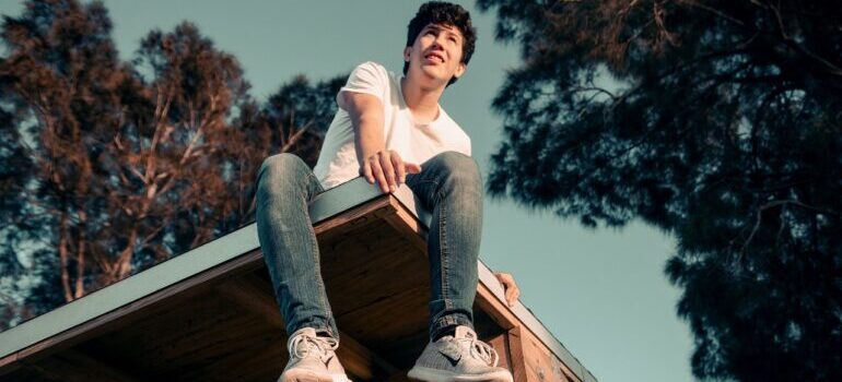 A man sitting on the roof.