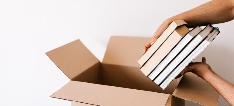 person taking books out of a box