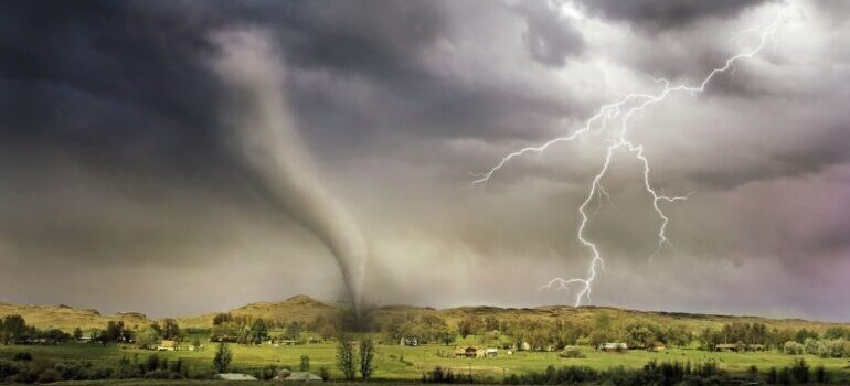 A tornado and a lightning bolt hitting the ground.