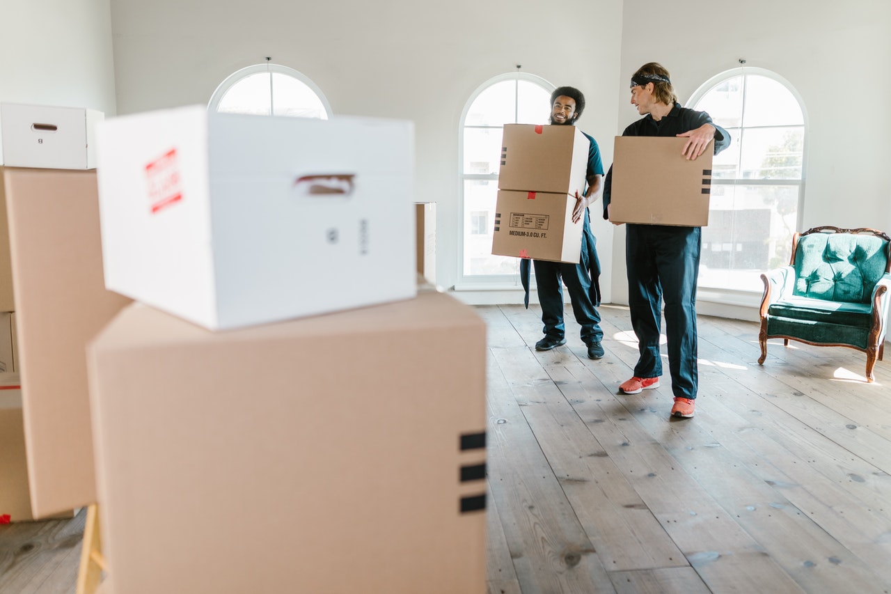 Two movers carrying boxes