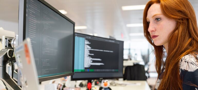 A woman coding on a PC