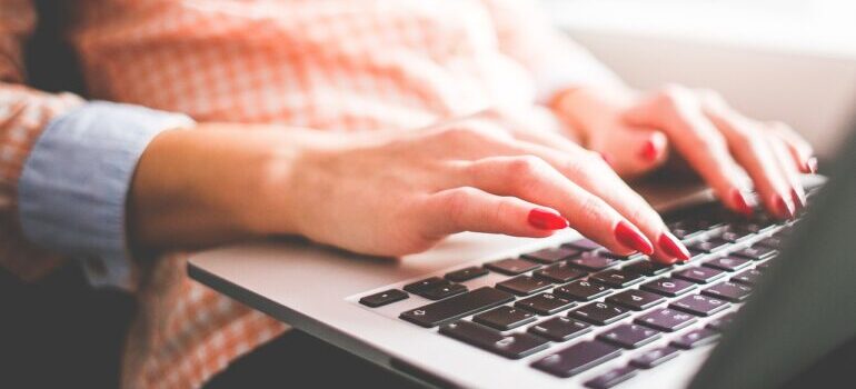 A woman searching for top movers in San Francisco on a laptop.