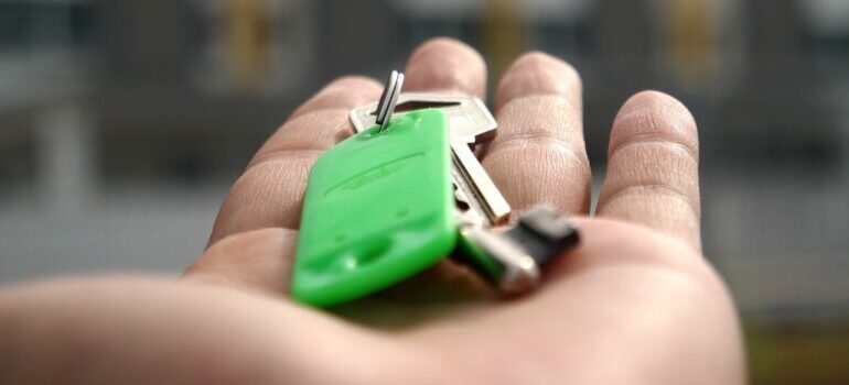 A person holding keys in hands.