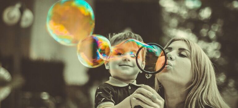 A mother and son blowing bubbles. 