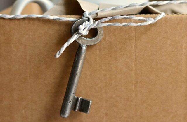 key tied to a cardboard box
