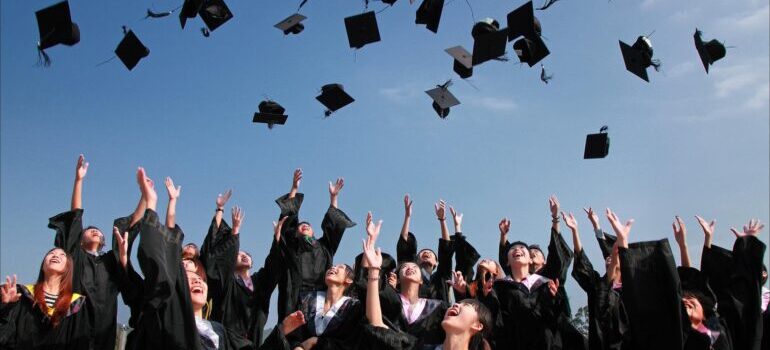 Graduated students throwing their hats 