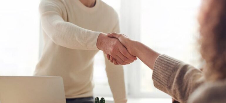 Two people shaking hands in the office