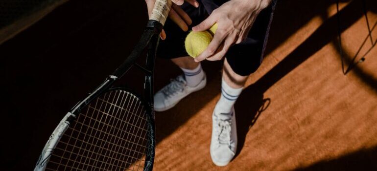A person is holding a tennis racket