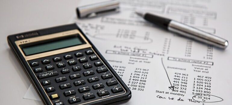 A calculator and papers for taxes. 