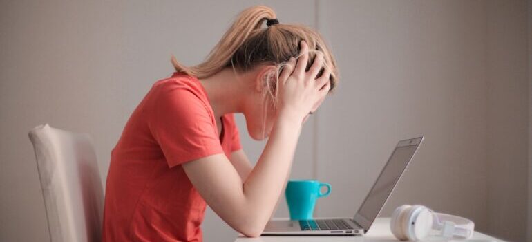 A woman holding herhead in frustration.