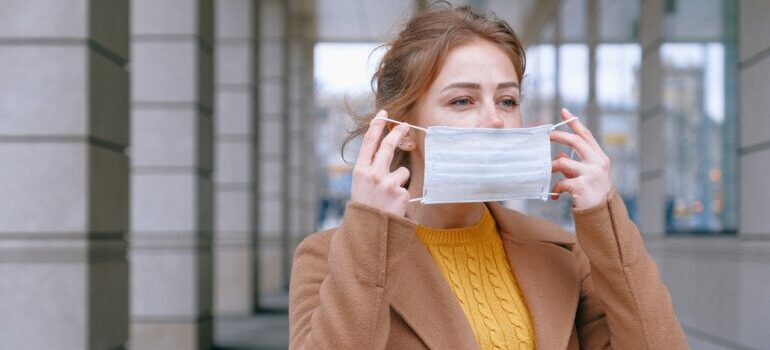 A woman putting on a mask.