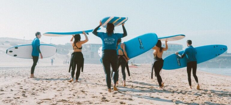 A group of surfers on a beach.