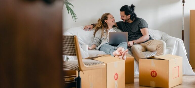 A young couple resting from packing for a move.