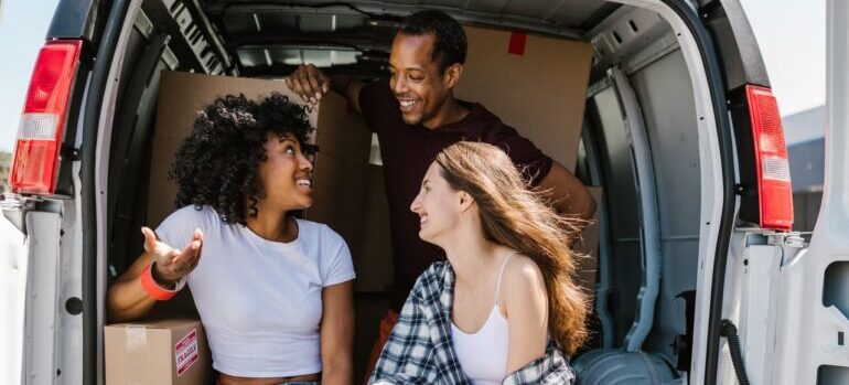 Two customers talking to a mover and smiling.