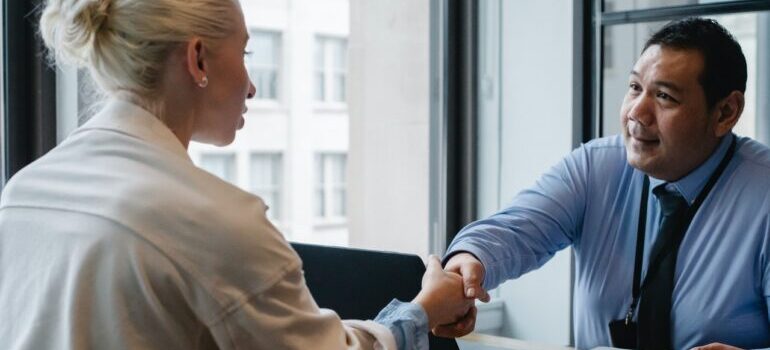 An employee shaking hands with a client.