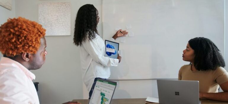 person pointing at a whiteboard