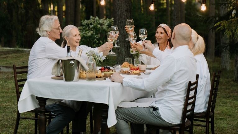 A group of elderly people having dinner.
