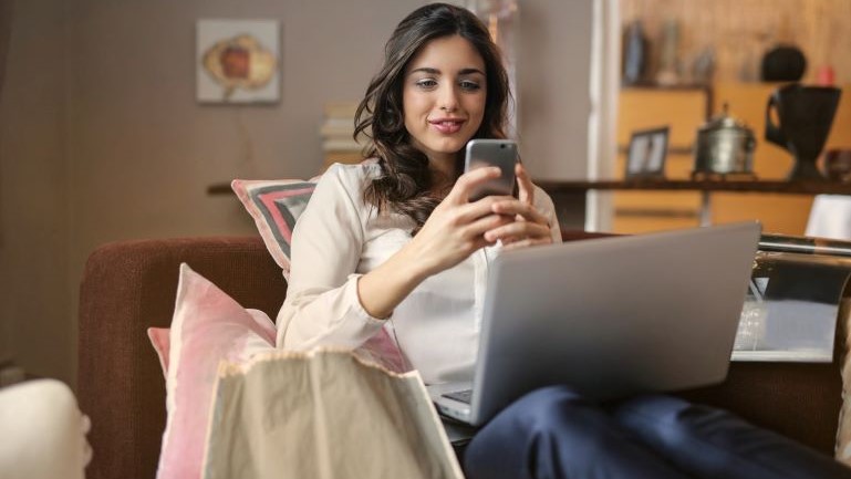 A woman looking up the best cities for job seekers in the U.S.