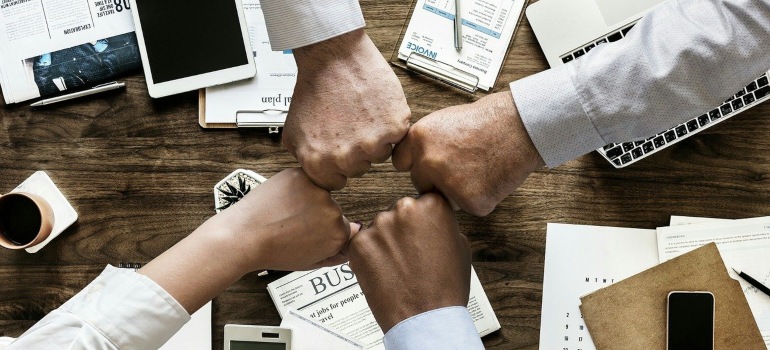 A group of people bumping fists.