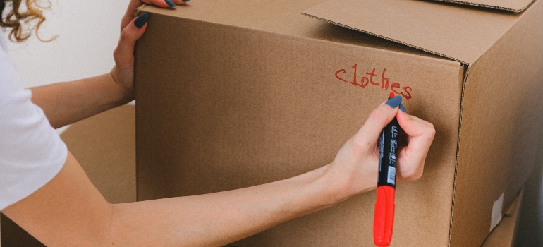 a woman writing what's inside the box