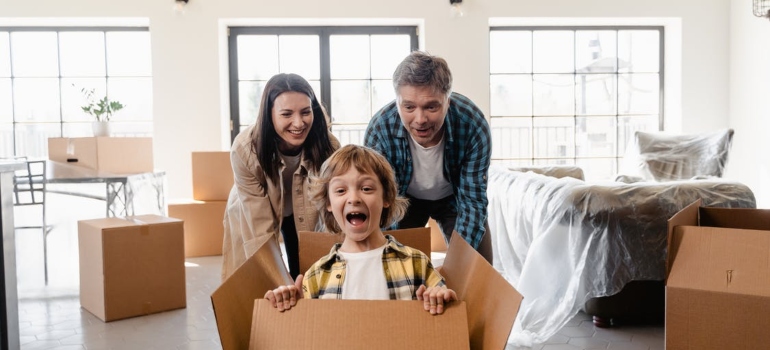 Happy family surrounded by moving boxes