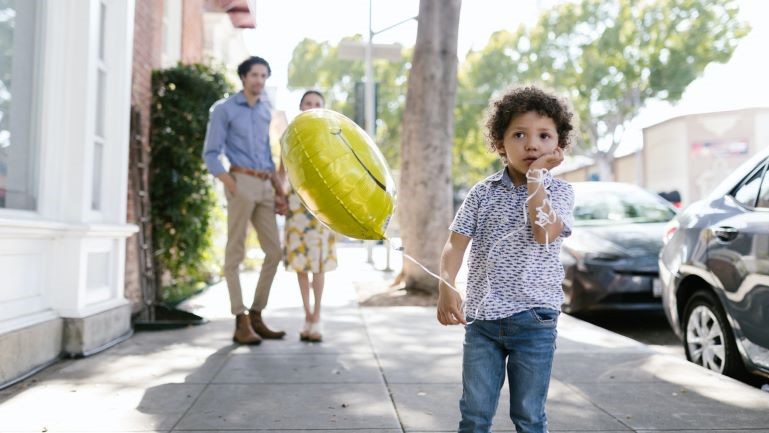 Little boy holding a baloon.