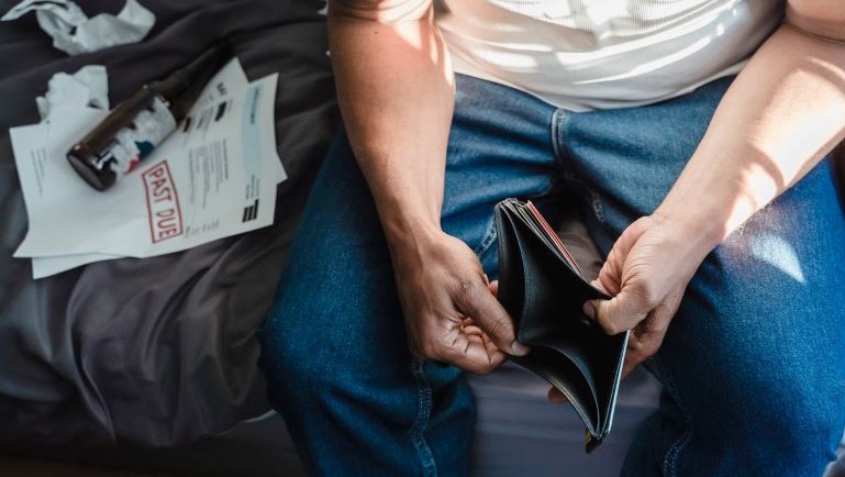 A man holding an empty wallet.