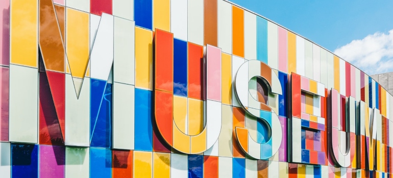 'museum' sign on a side of a building in various colors