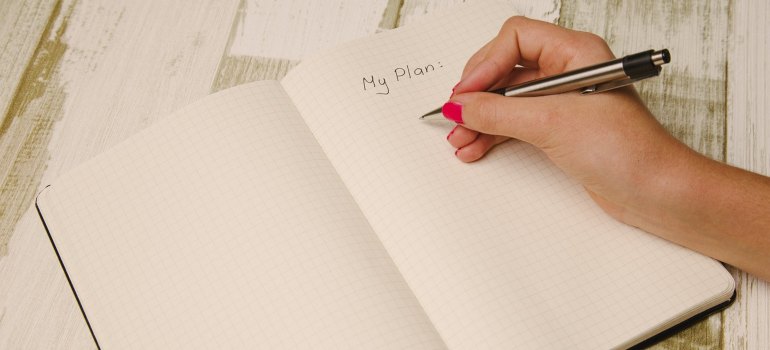 A woman writing down a plan. 