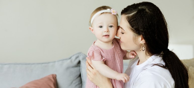 A mother holding her daughter. 