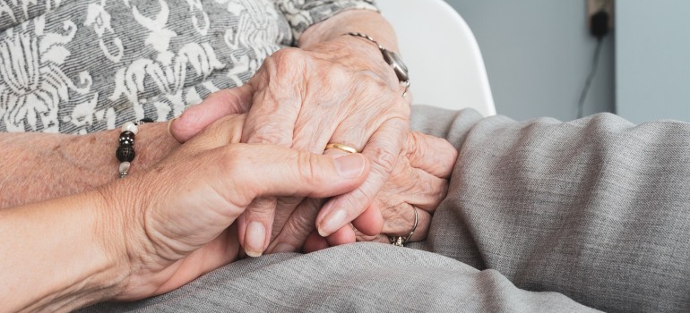 Senior citizens holding hands.