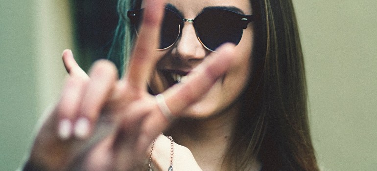 A young woman showing the peace sign.