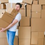 a man holding a pile of boxes
