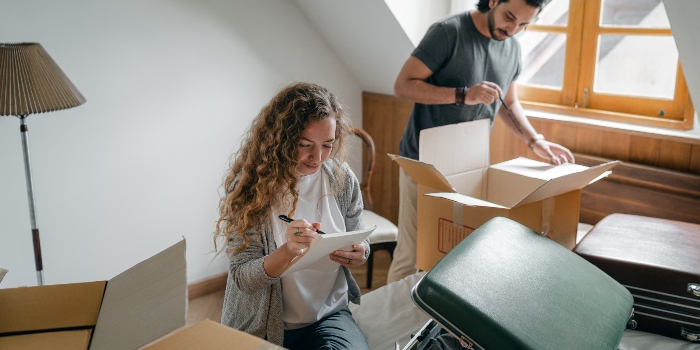 A couple making a to-do list for moving into a new home