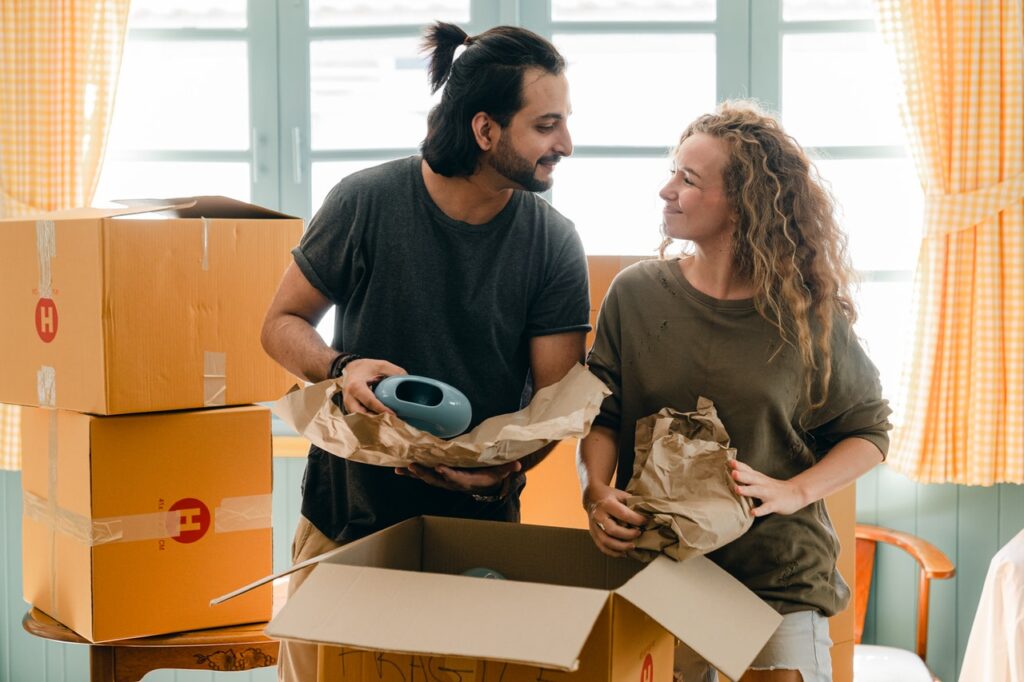 a man and a woman packing boxes, remembering the days when they were moving as a student
