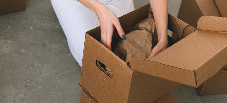 a woman packing a box