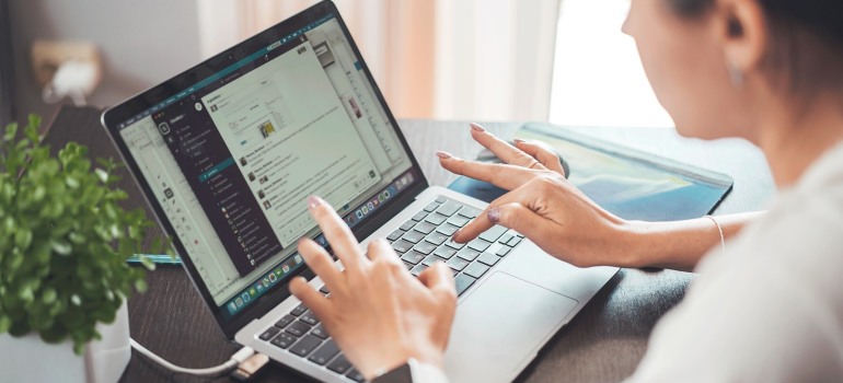 A woman working on a laptop.