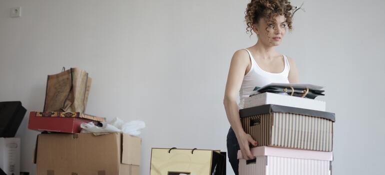 A woman taking out boxes out of the bedroom