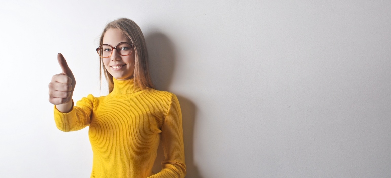 happy young woman in yellow turtleneck shirt
