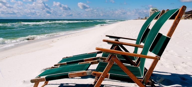 Two chairs on the beach.