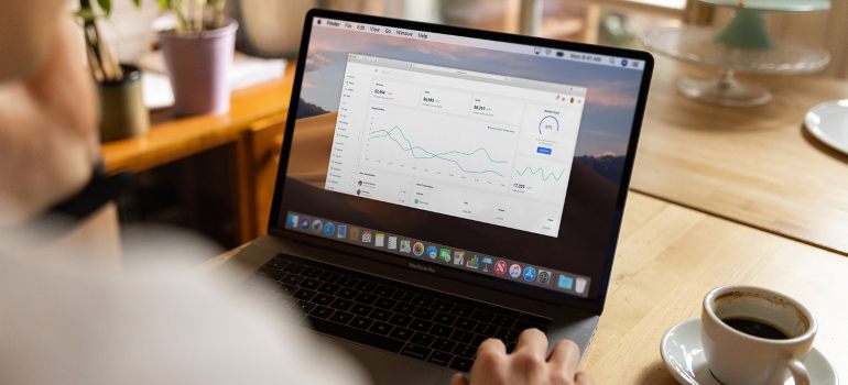 A woman looking at a chart on a laptop.