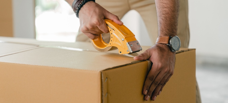 a person taping a box