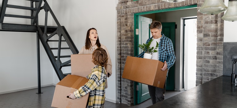 people entering their new home after relocation with the help from long distance moving companies Beaverton